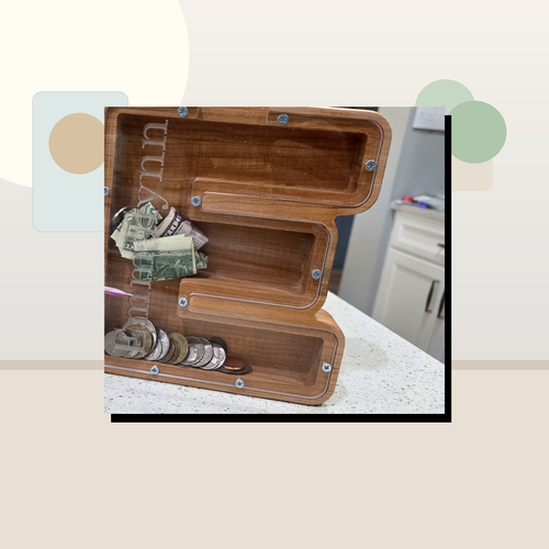 Clean staged lifestyle scene for wooden letter coin bank by Vega Woodwork
